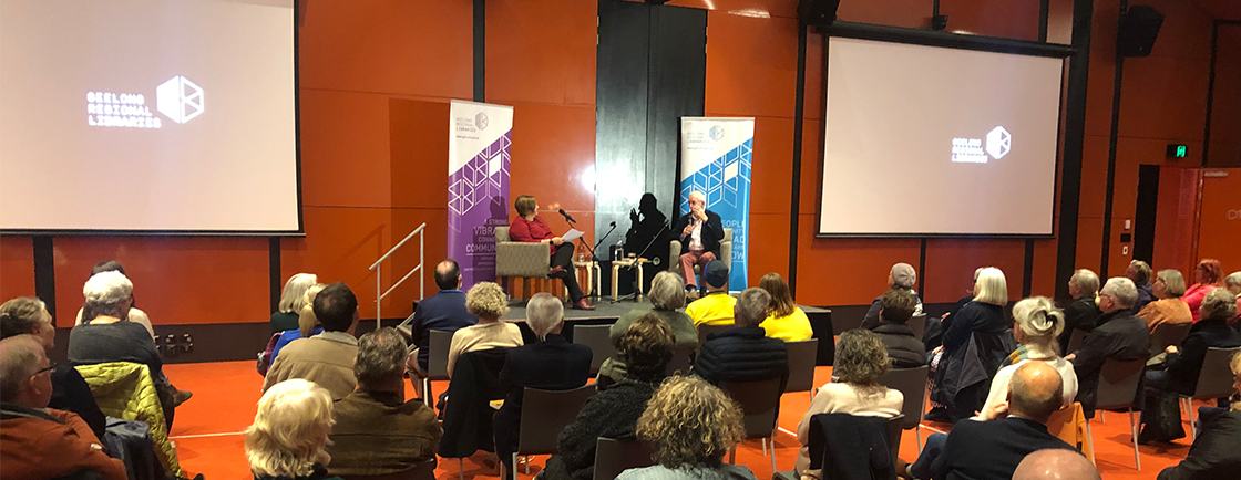 Photograph of a literary event at Geelong Library, with two people discussing a book on stage 