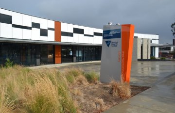 Outside the front of Western Heights College Library building. Sign in foreground