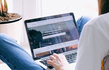 Image description: A woman sits at her computer 