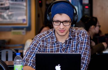 Man on laptop with headphones