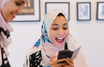 Young woman in head scarf, smiling