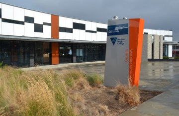 Outside the front of Western Heights College Library building. Sign in foreground